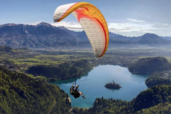 A paraglider above Lake Bled with the island directly below